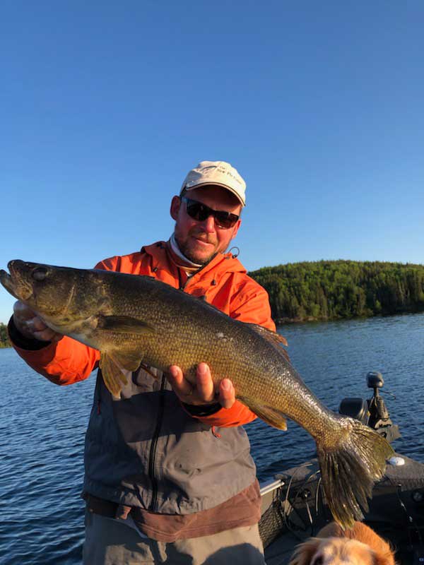 angler fly fishing walleye