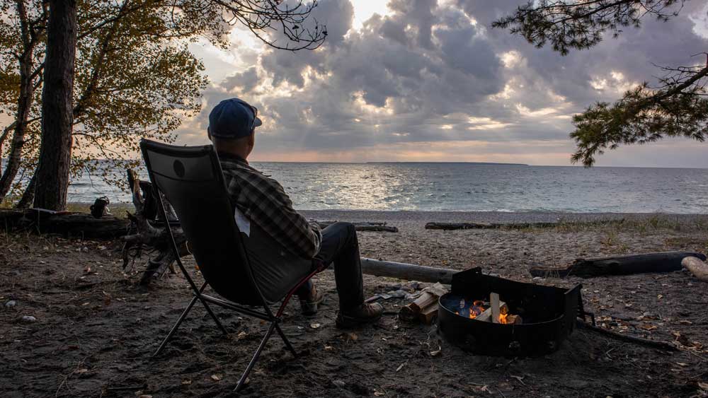fall camping campfire lake view