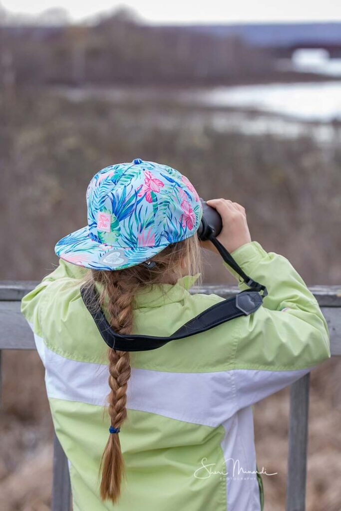 person looking through binoculars