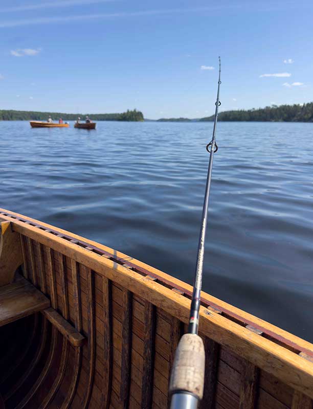 fishing road leaning against a boat
